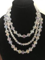 Triple Strand Faceted AB Crystal Necklace with Fancy Silver Dipped Clasp. Approximately 22 inches.